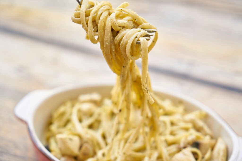 pexels photo 2703468 2703468 A close-up of creamy Italian pasta with basil and cheese, perfect for a delicious meal.